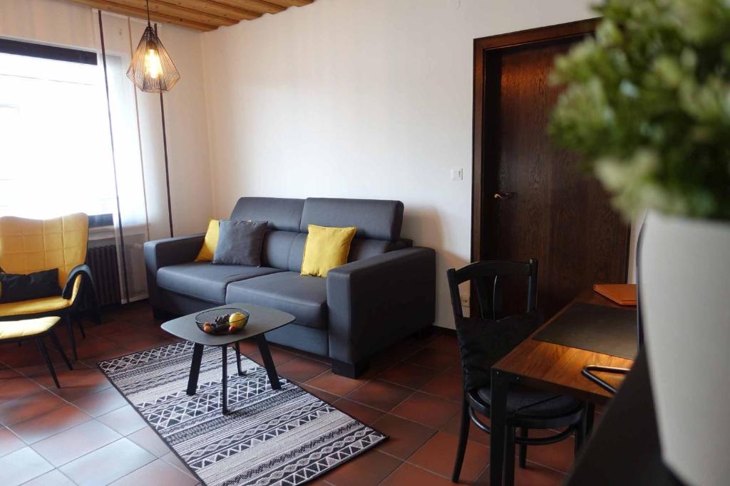 a living room with a couch and a table at Fewo Lehner in Riedenburg