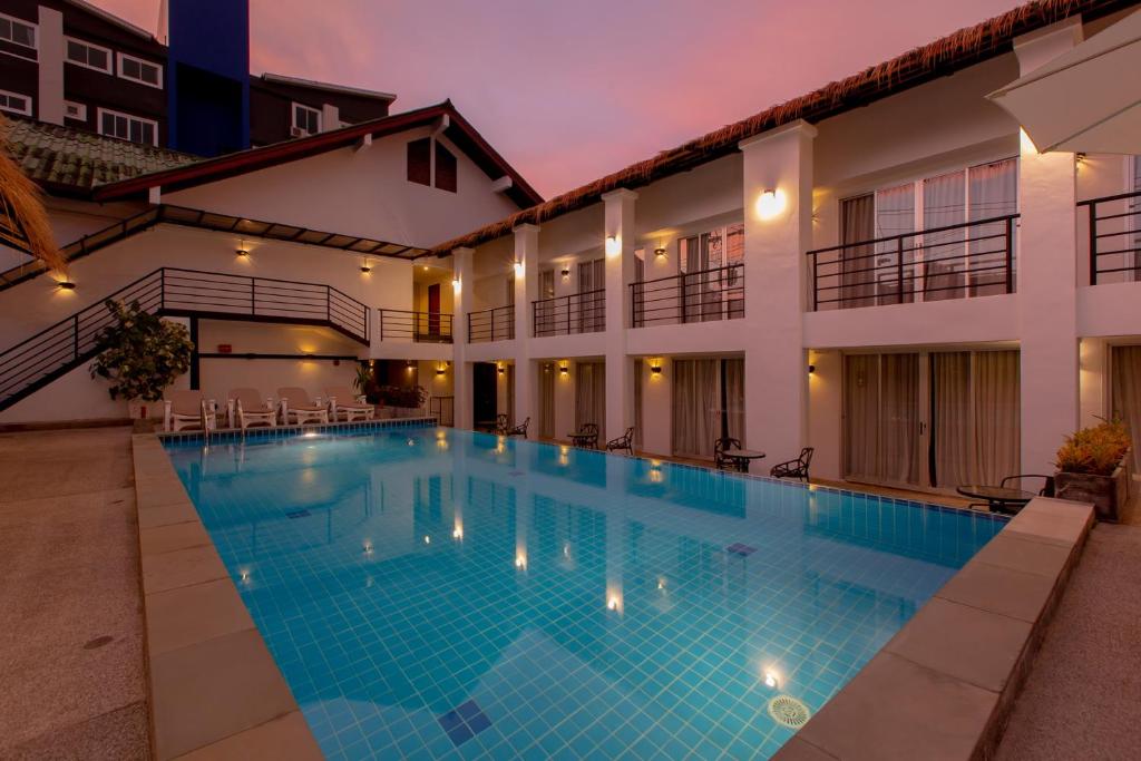 a swimming pool in the middle of a building at The Nest Resort Patong in Patong Beach