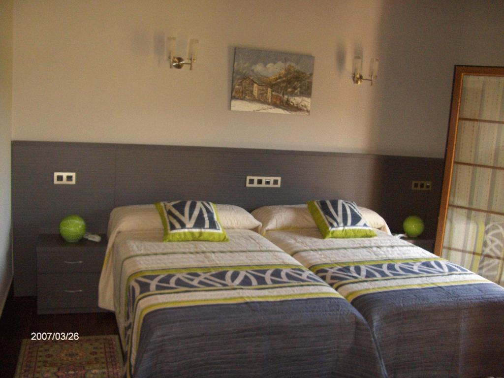 dos camas sentadas una al lado de la otra en un dormitorio en Hotel Rural Las Palmeras Muskiz, en Muskiz