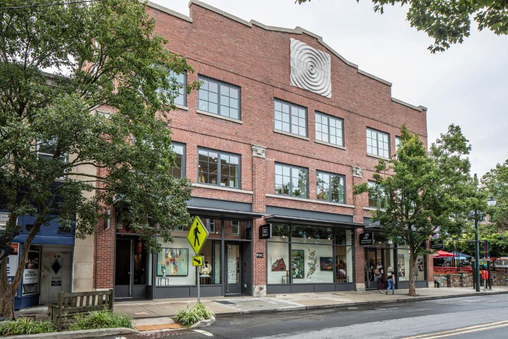 a red brick building on a city street at Elevation Lofts Hotel in Asheville