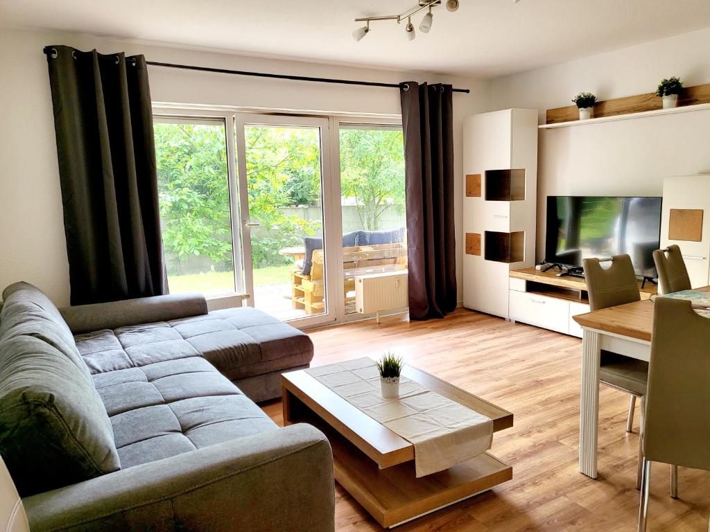 a living room with a couch and a table at Exklusivwohnung Nempitz in Nempitz
