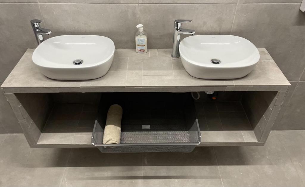 two sinks on a counter in a bathroom at Medano Nest Hostel in El Médano
