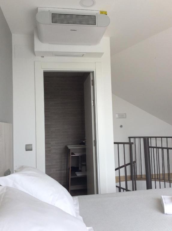 A bed or beds in a room at Apartamentos Hostería de Boo