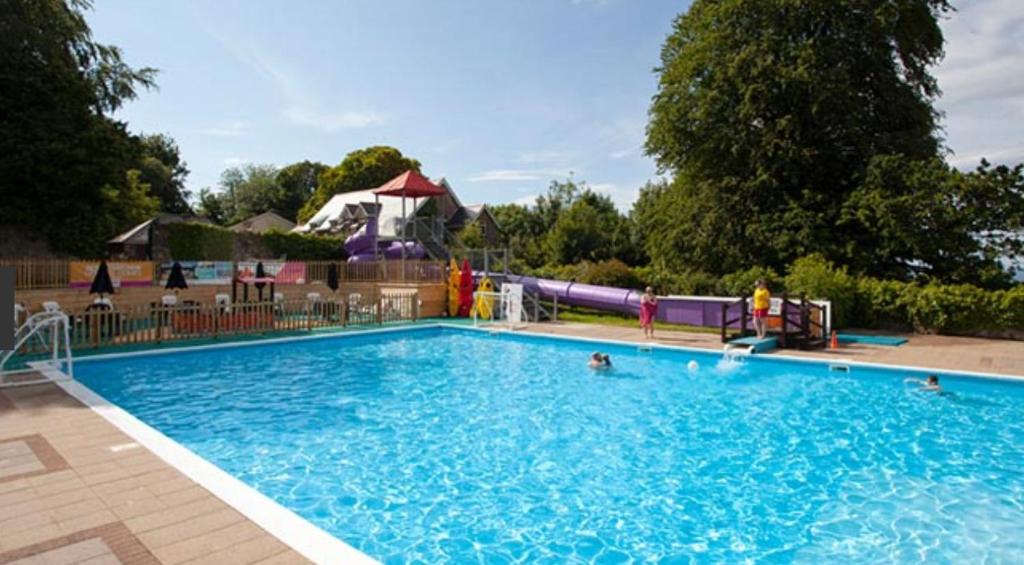 a large swimming pool with people in the water at Parkdean Sea Valley chalet Westward Ho! & Bideford in Bideford