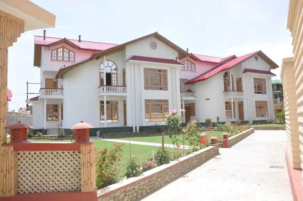 a house with a fence in front of it at Hotel Al Azrah in Srinagar