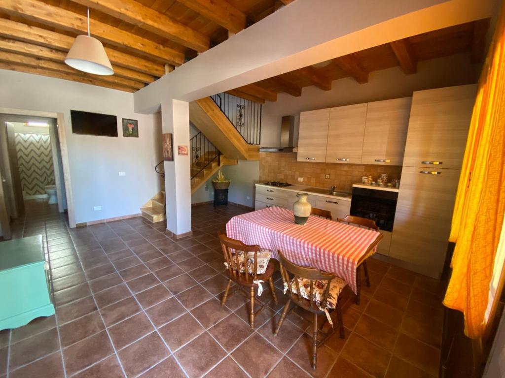 a kitchen and dining room with a table and chairs at Colle Paciocco in Tivoli