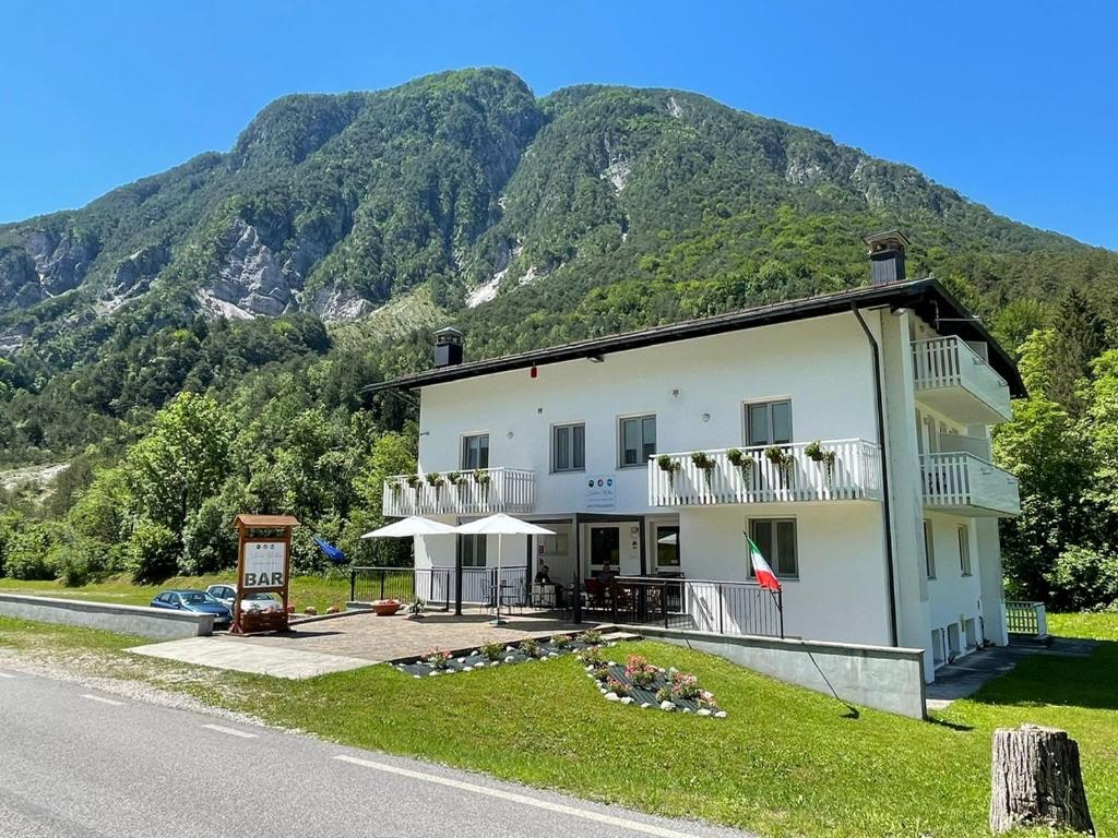 a building on the side of a road with a mountain at B&B Stari Mlin - Vecchio Mulino in San Giorgio