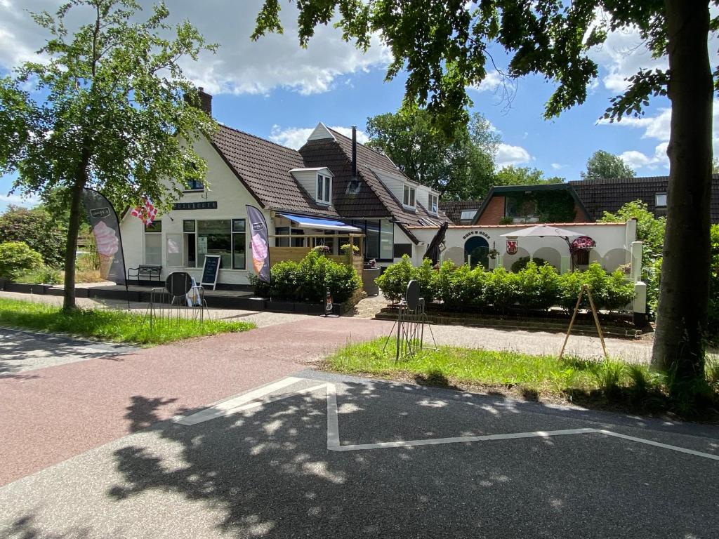 a building with a trailer parked in a parking lot at De Posthoorn in Appelscha