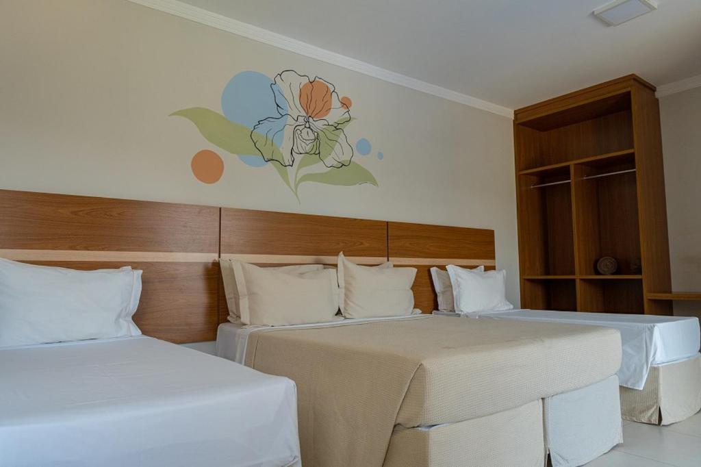 Postel nebo postele na pokoji v ubytování Orquídeas Praia Hotel