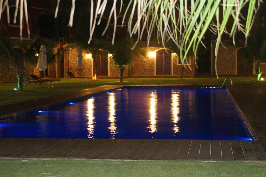 una piscina por la noche con luces en Flat La Fazenda, en Canoa Quebrada