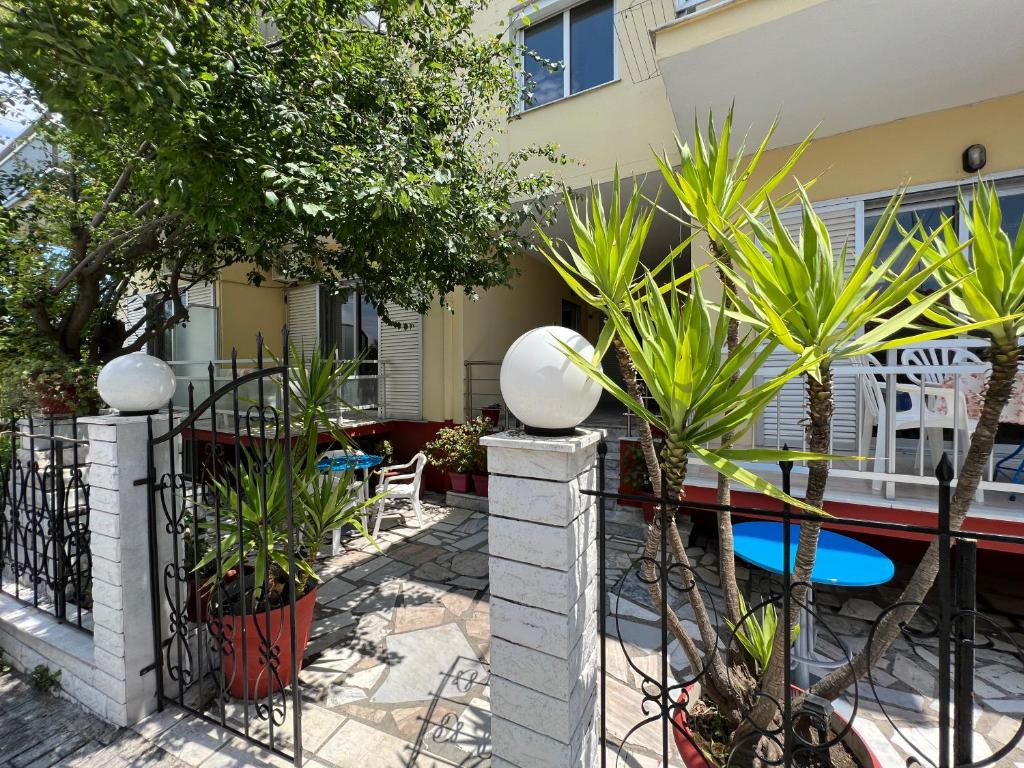a fence with plants in front of a house at Villa Eleni - Thassos Town in Limenas