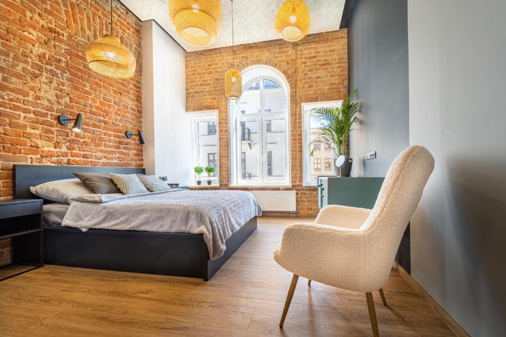 a bedroom with a bed and a brick wall at Królicza Norka in Lublin