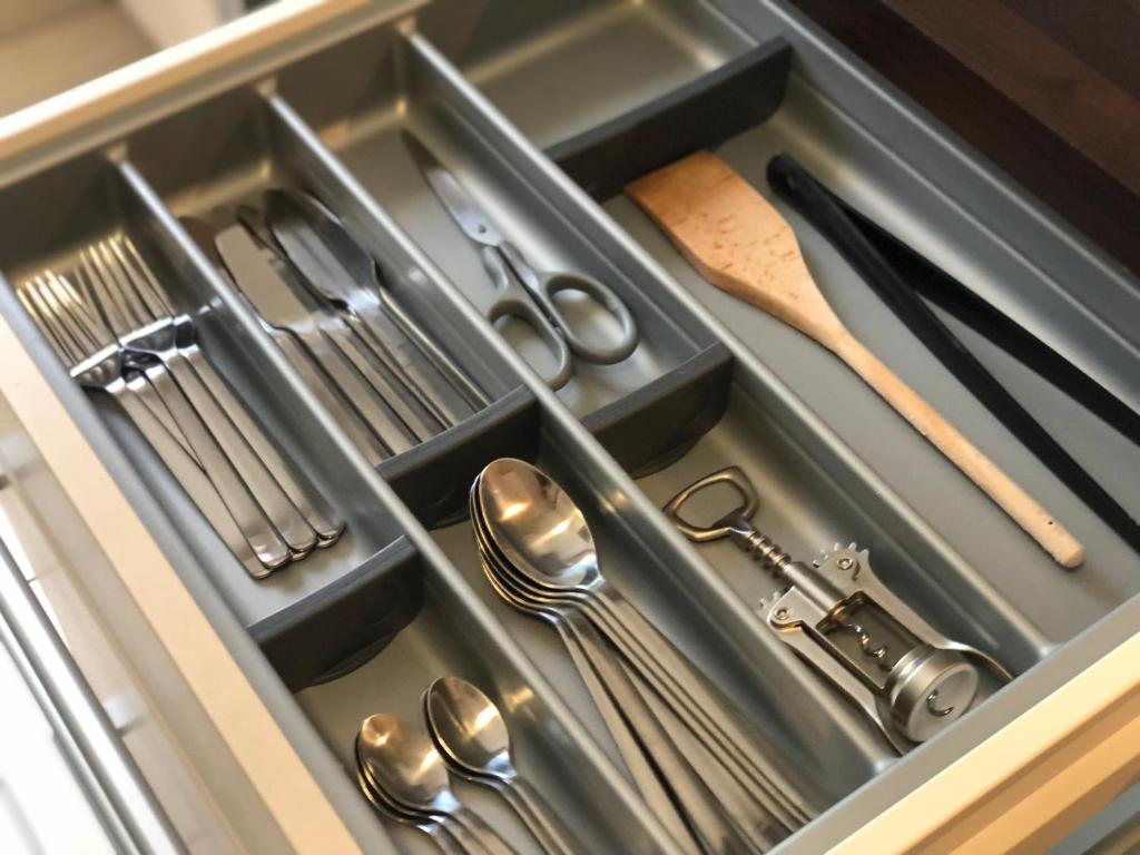a drawer filled with silver utensils in a kitchen at Beautiful Apartment near Geneva in Saint-Julien-en-Genevois