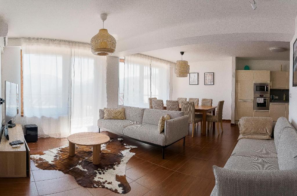 a living room with couches and a dining room at Panorama apartmán 44-C in Donovaly