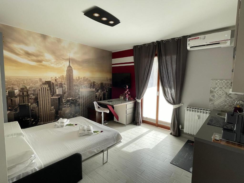 a bedroom with a bed and a painting of a city at Studio Flat Policlinico G B Rossi Borgo Roma in Verona