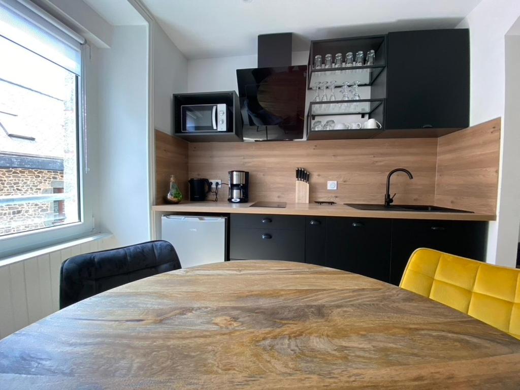 una cocina con una gran mesa de madera y sillas amarillas en +NOUVEAU+ BINIC Port ET Plage, en Binic