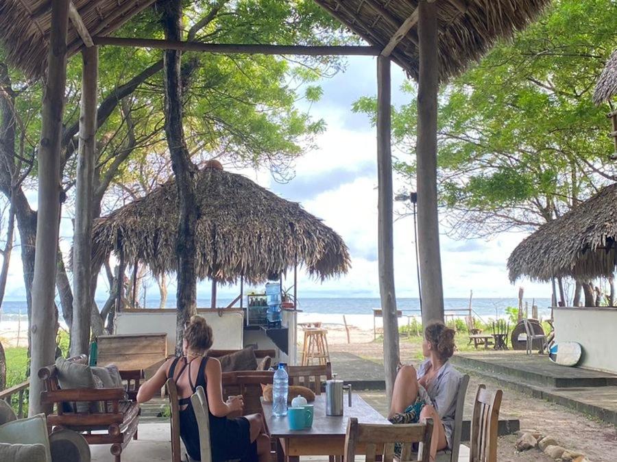 two women sitting at a table on the beach at Popoyo Surfcamp in Popoyo