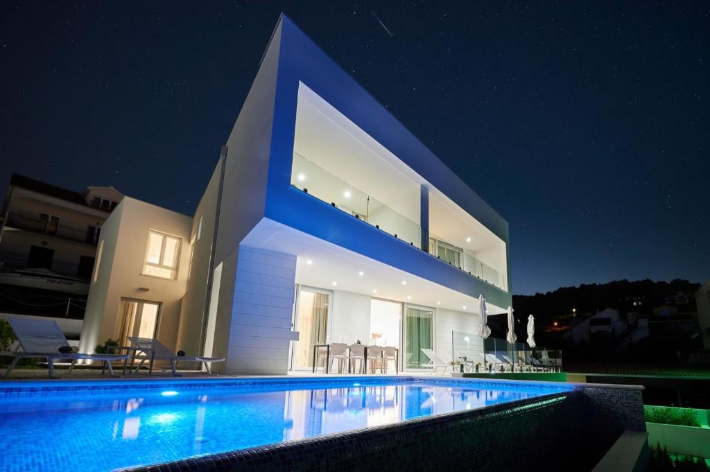 a large house with a swimming pool at night at Villa Trogir 2 in Trogir