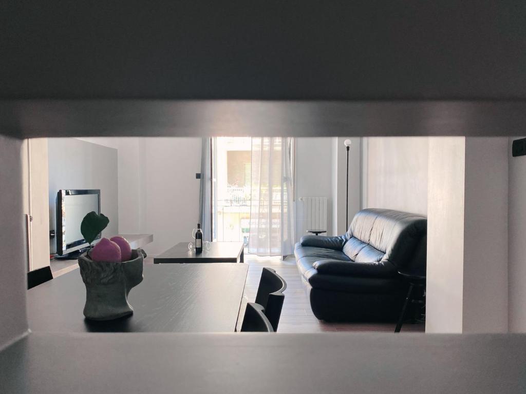 a living room with a couch and a table at duo apartment in Salerno