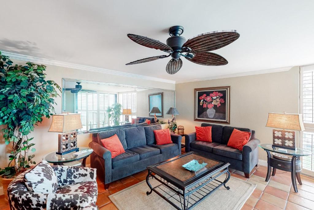 a living room with a couch and a ceiling fan at Mainsail 244 in Destin
