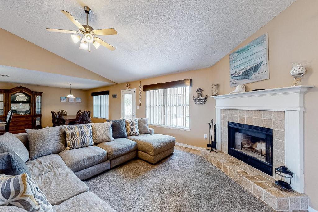 a living room with a couch and a fireplace at Emerald Coast Dream Haven in Navarre