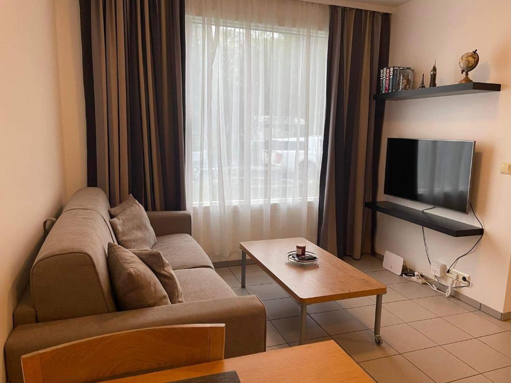 a living room with a couch and a tv at Eyrakot Studio-Self-check-in apartment in Selfoss city center in Selfoss
