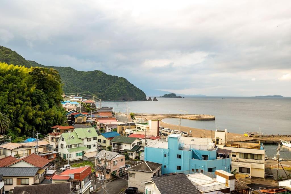 a group of houses and buildings next to the water at MR. TOMO KAWANA in Kawana