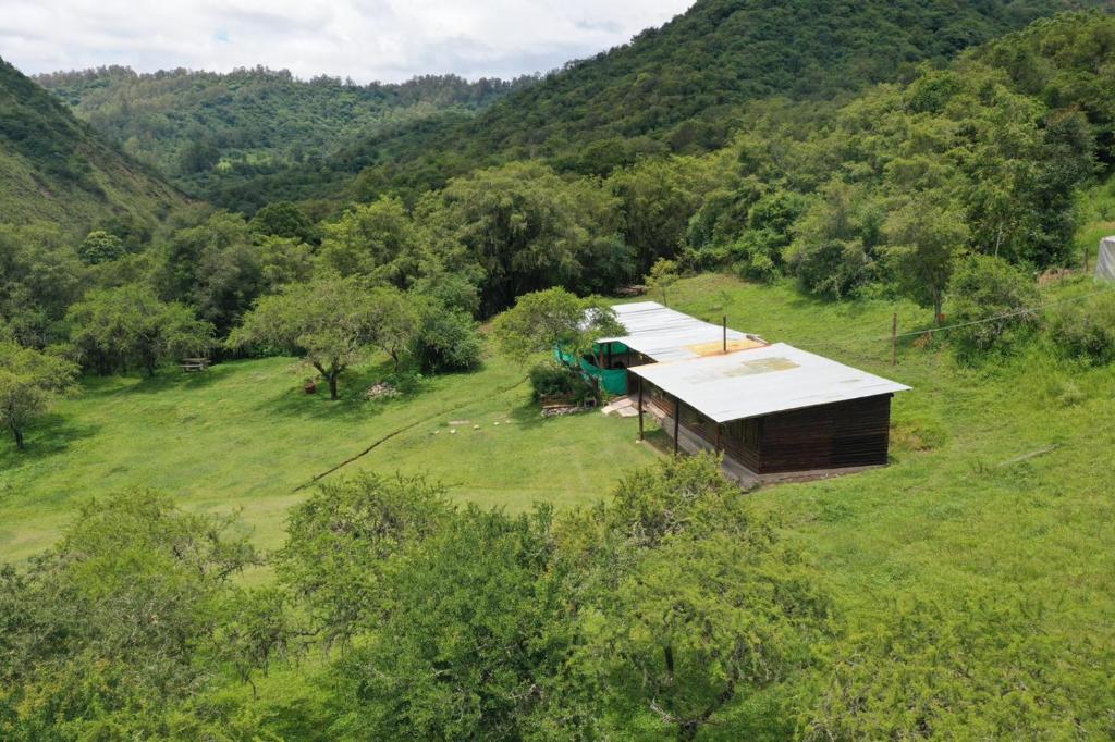 an overhead view of a building on a hill with trees at barro blanco turismo rural in Villa Achával
