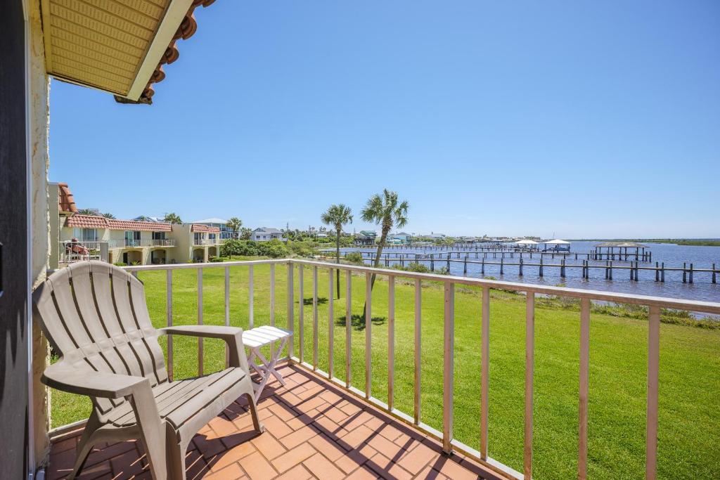 a balcony with a chair and a view of the water at Point Matanzas B3 in St. Augustine