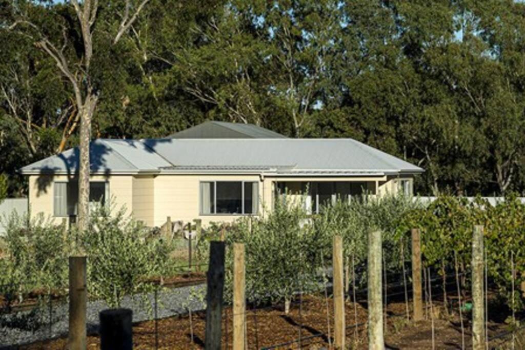 a white house with a fence in front of it at CASALE COTTAGE Barossa Valley in Nuriootpa