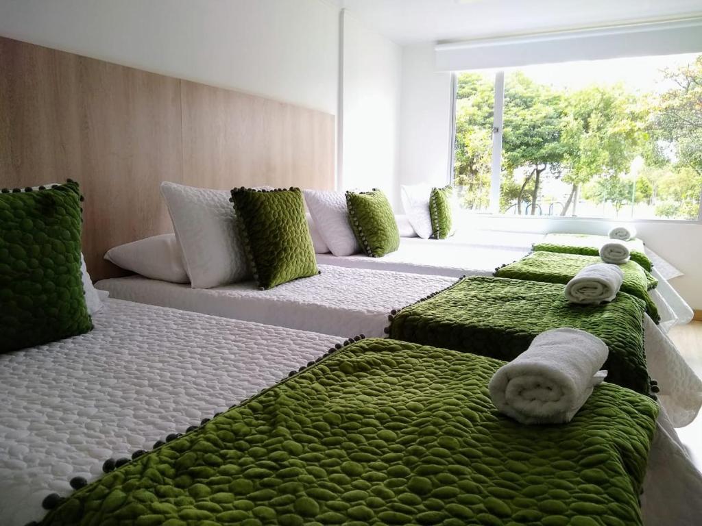 Postel nebo postele na pokoji v ubytování Hotel Federman Park Bogota