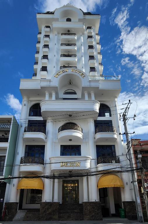 a white building with balconies on the side of it at Dezon Hotel in Quy Nhon