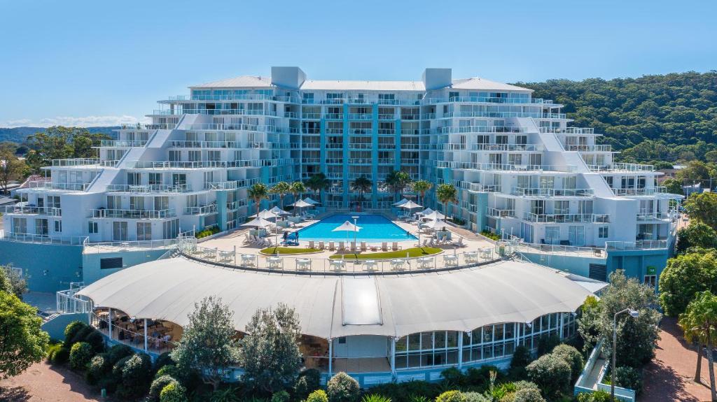 an aerial view of a large building with a pool at Mantra Ettalong Beach in Ettalong Beach