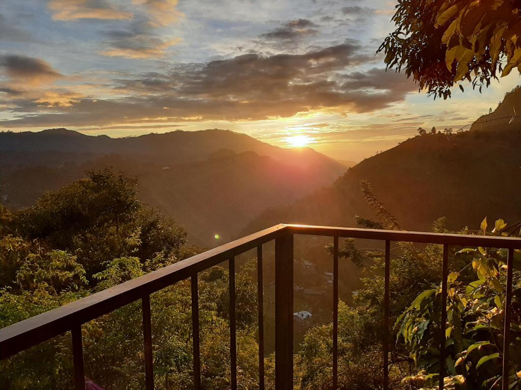a view of the sun setting over the mountains at Glorious Nature Inn in Ella