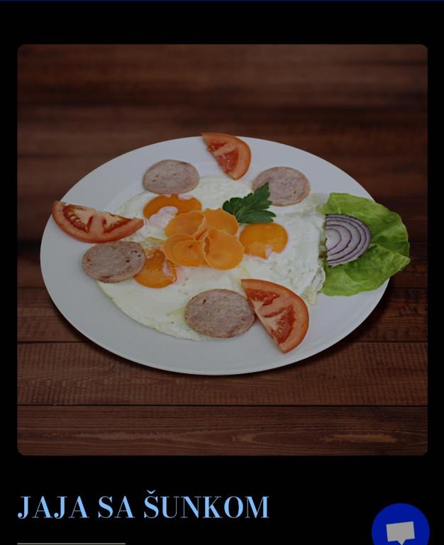a plate of food with sausage and vegetables on it at Greenspace in Niš
