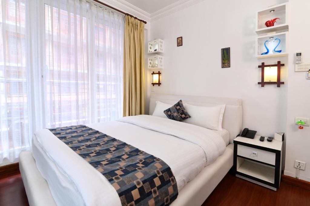 Postel nebo postele na pokoji v ubytování Hotel M Square Pvt.Ltd