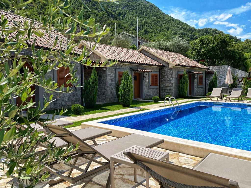 a villa with a swimming pool and a house at Eco Villas Merak in Virpazar
