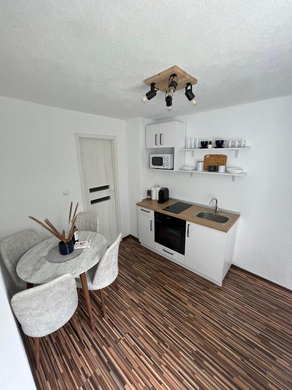 a small kitchen with a table and a sink at Apartament in regim hotelier Queen Medias in Mediaş