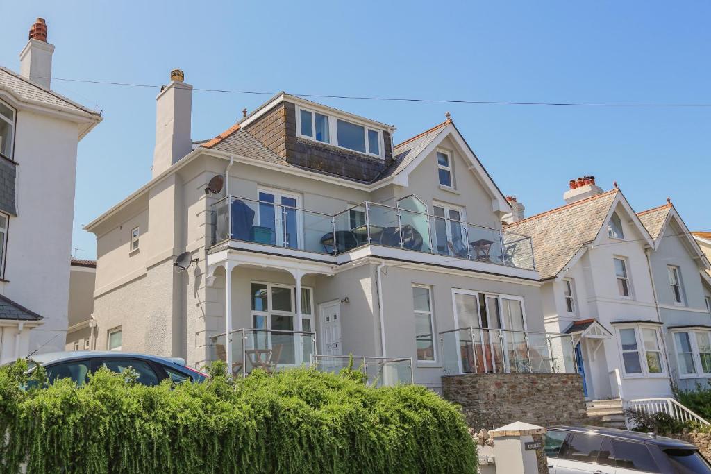 a large white house with a balcony at 4 Lyndhurst in Salcombe