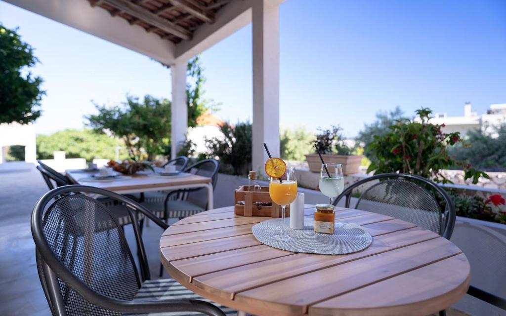 a wooden table with a glass of orange juice on a patio at Pansion Jakas in Zavala