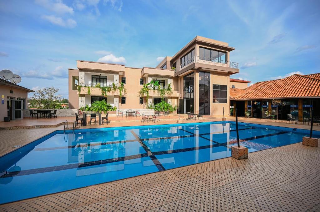 a large swimming pool in front of a house at Grazia Apartments in Kigali