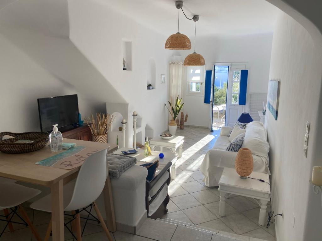 a living room with a couch and a table at Sea and Sun beach house at Platis Gialos in Platis Gialos