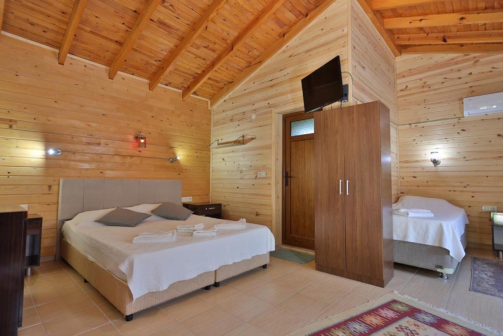 Postel nebo postele na pokoji v ubytování Safir Pansiyon