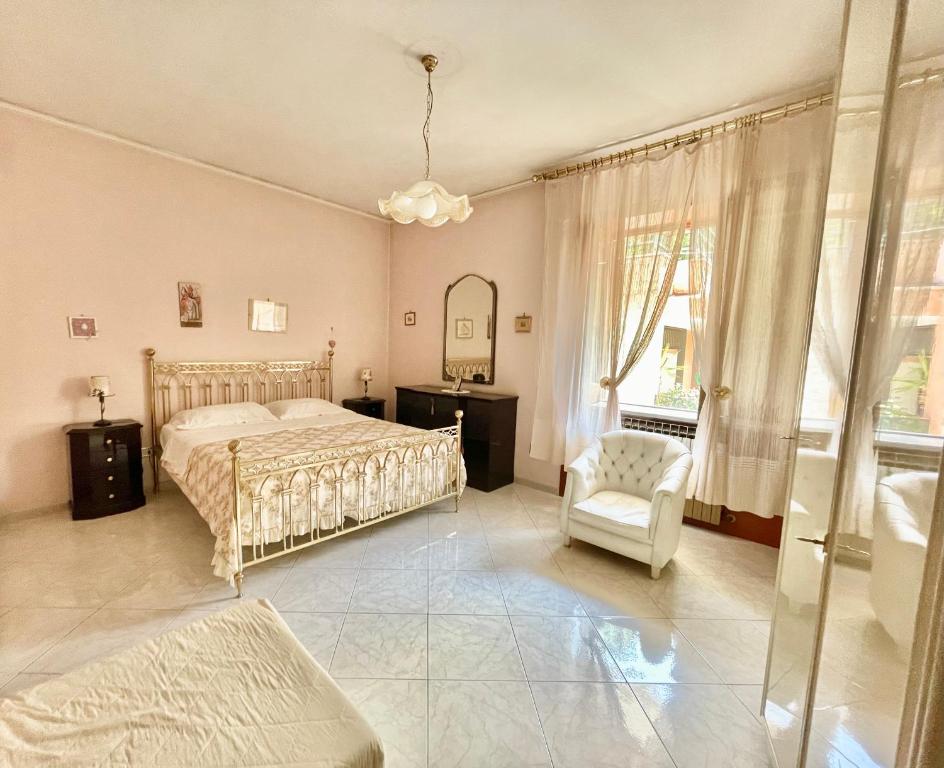 een slaapkamer met een bed, een stoel en een spiegel bij La Casa Di Lina in Baiano