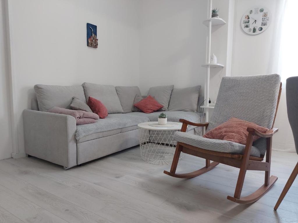 a living room with a couch and a chair at Apartman Nora in Ubli