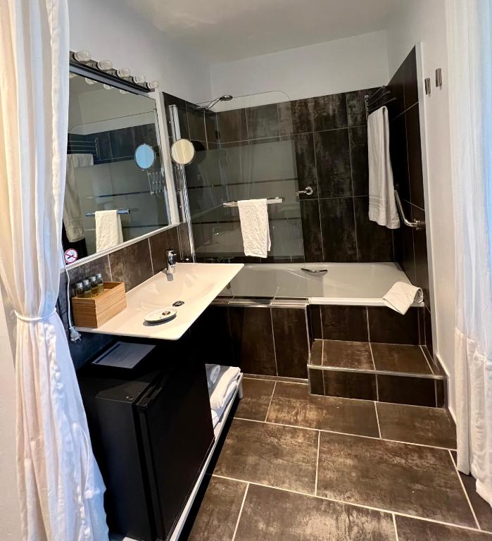 a bathroom with a sink and a large mirror at Mazagonia in Mazagón