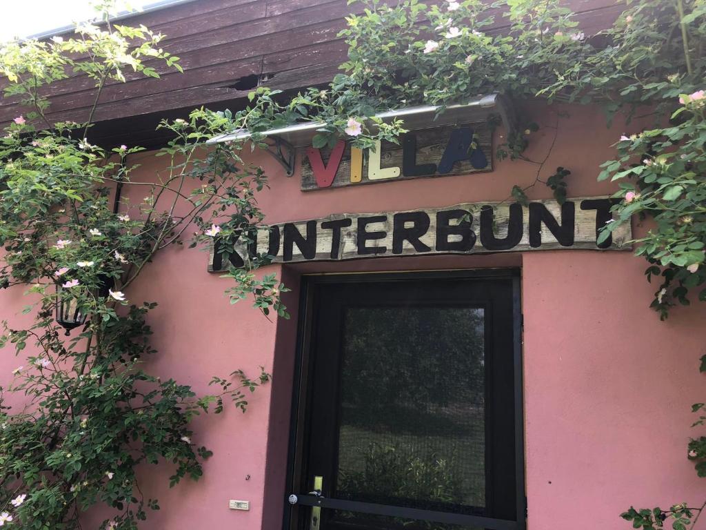a building with a sign above a door at Villa Kunterbunt Ostsee in Schashagen