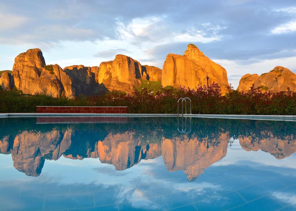 a pool in front of a rock formation at Meteora Hotel at Kastraki in Kalabaka