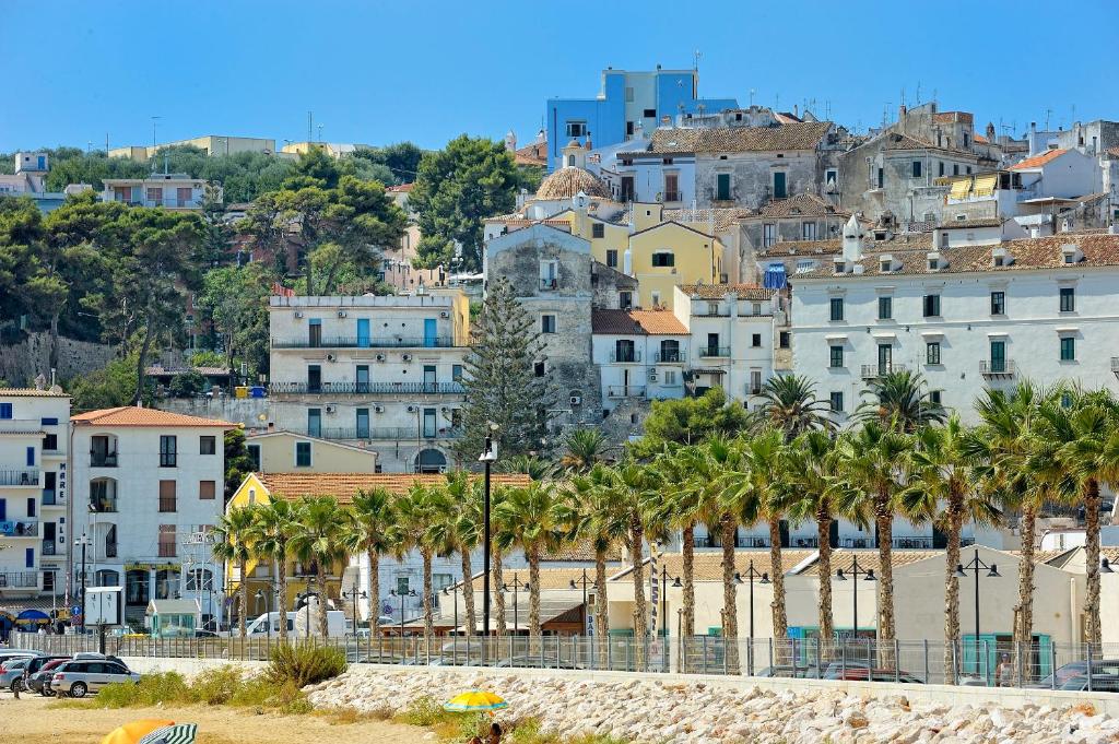 a view of a city with palm trees and buildings at Torre d'Oriente in Rodi Garganico