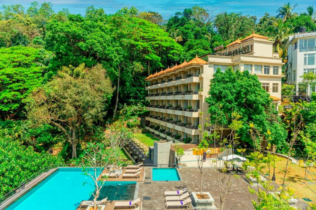 a house with a patio and a pool at Thilanka Hotel in Kandy
